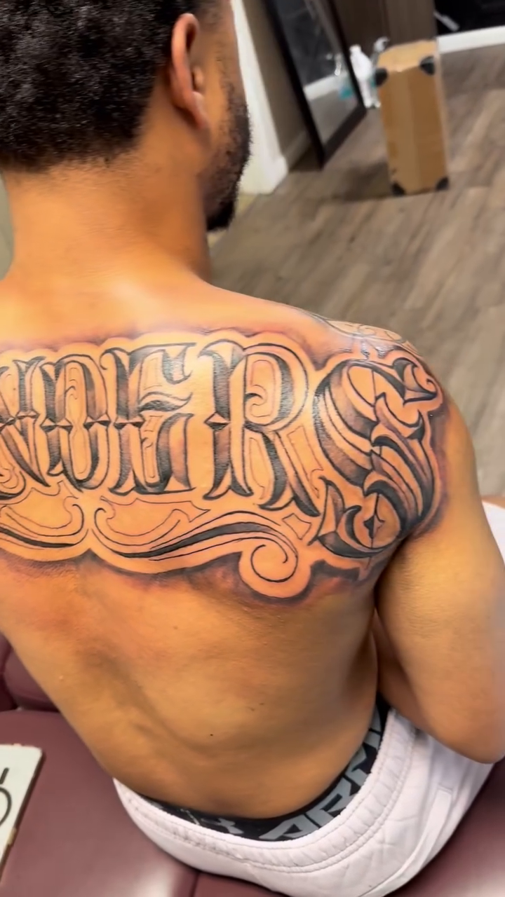 The word "Survivor" lettering script tattoo by Jared McGee