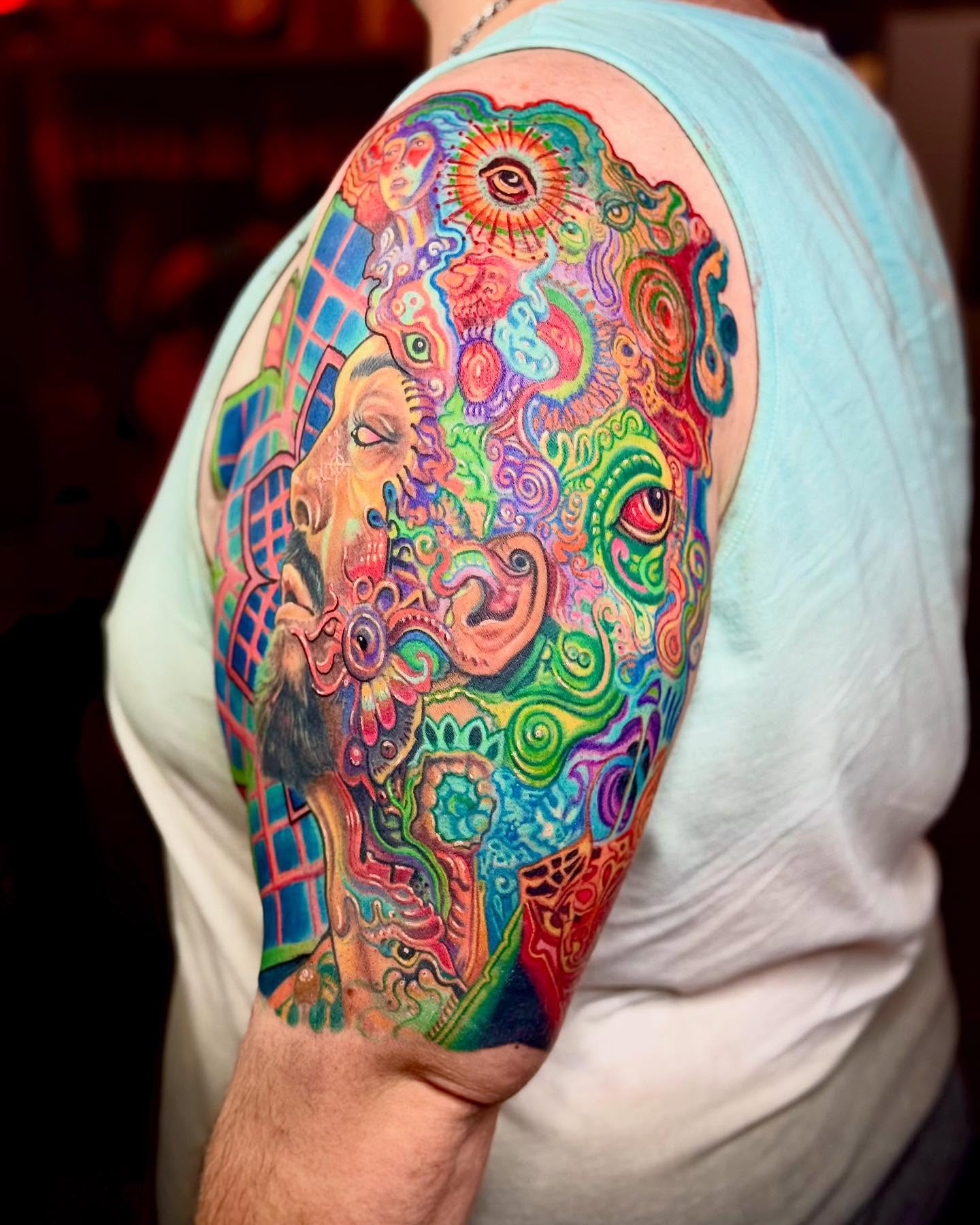Psychedelic face new school tattoo on the shoulder by Bacon 🥓