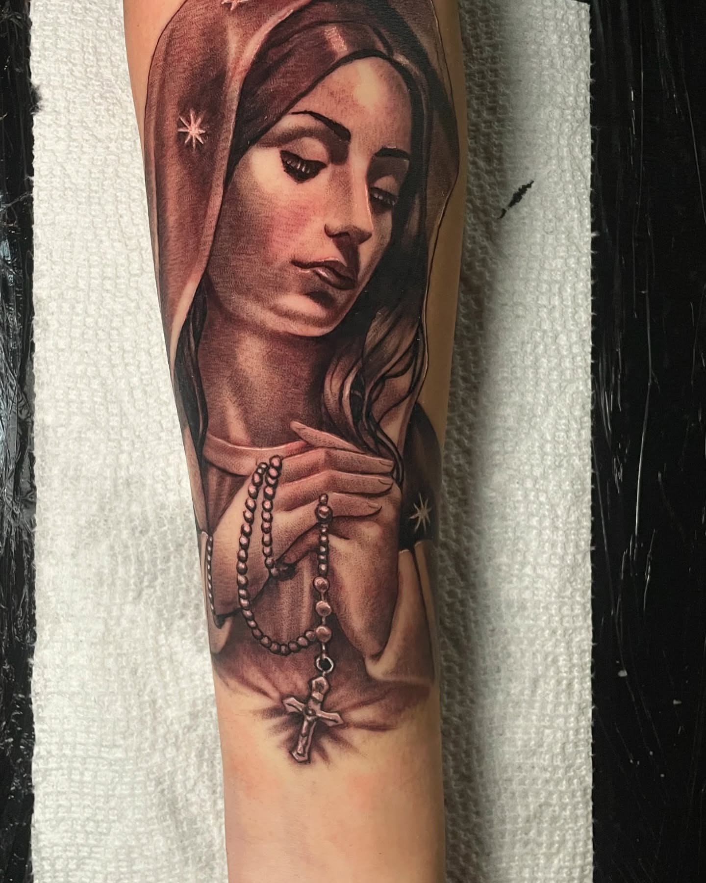 Religious figure realism tattoo on the forearm by Vic