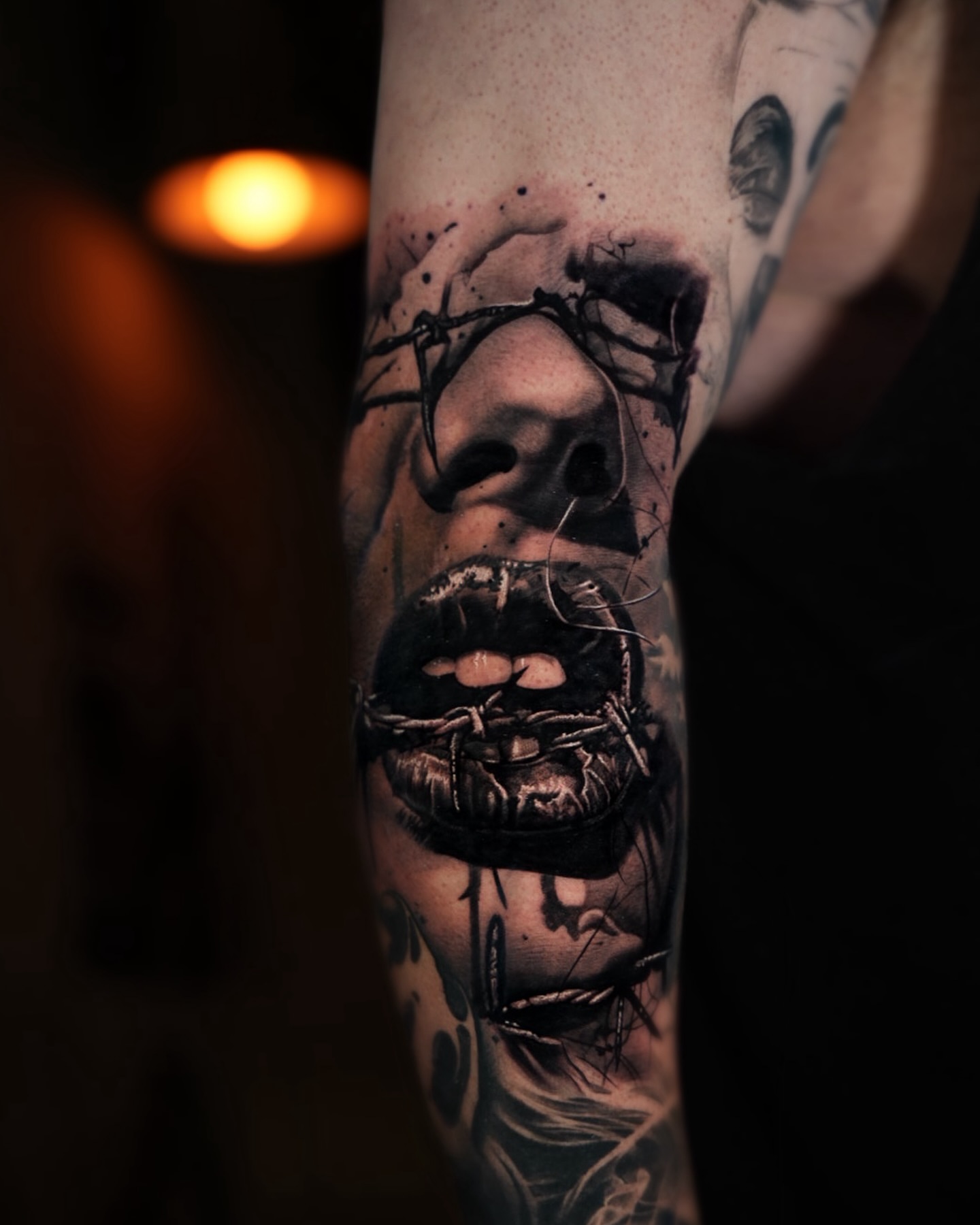 Horror face dark realism tattoo on the forearm by Bailey Lemus