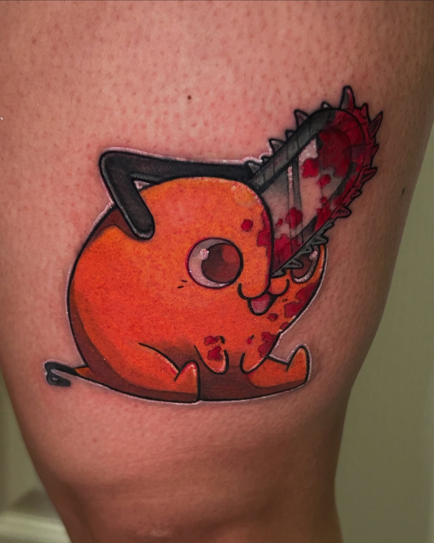 Chibi cat with chainsaw illustrative tattoo on the thigh by Mando Castro