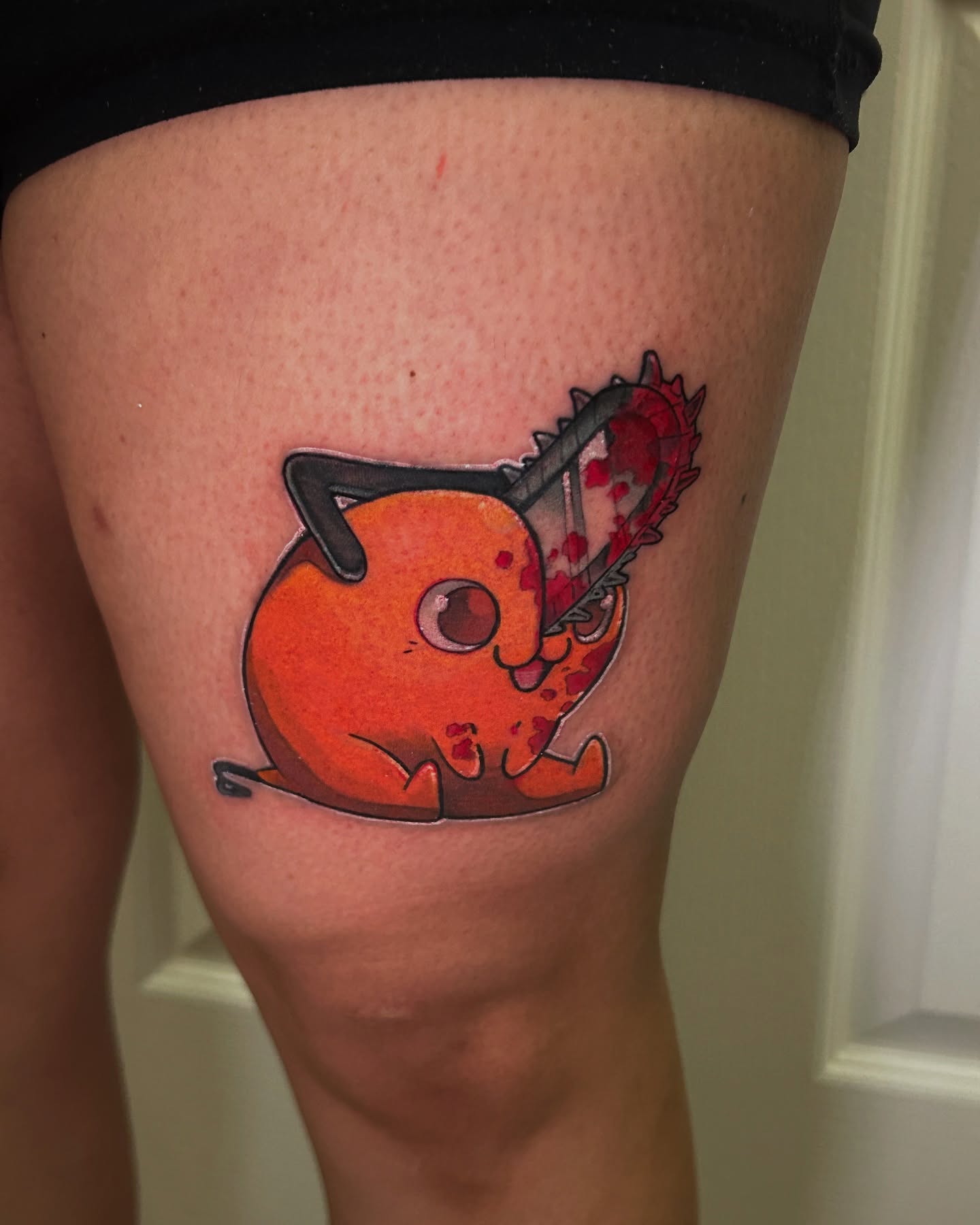 Cat with chainsaw dotwork tattoo on the thigh by Mando Castro