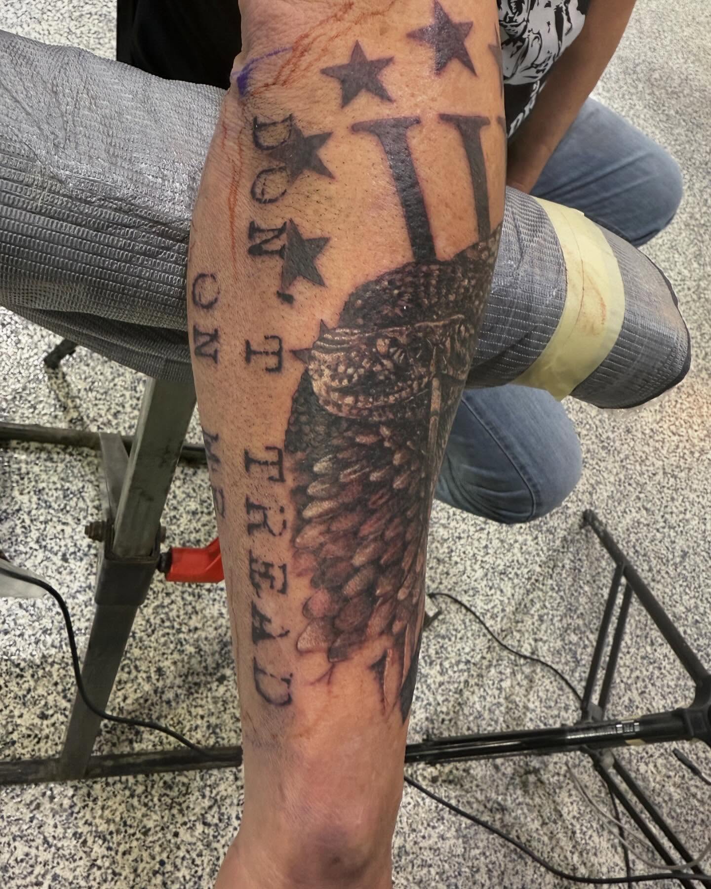 Snake and stars American traditional tattoo on the forearm by Troy Butner