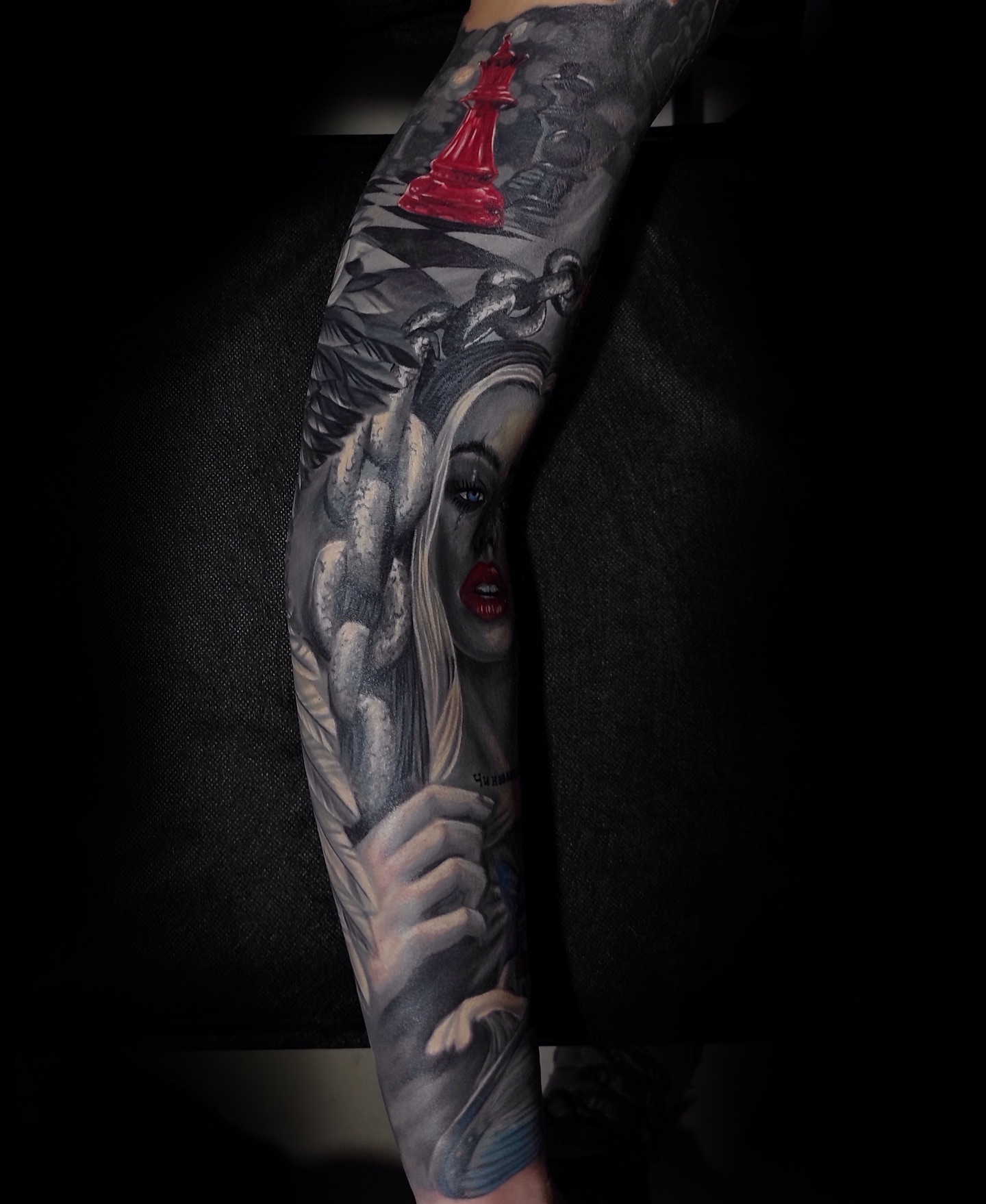 Woman with chess piece realism tattoo on the forearm by Vladimir Lutaev