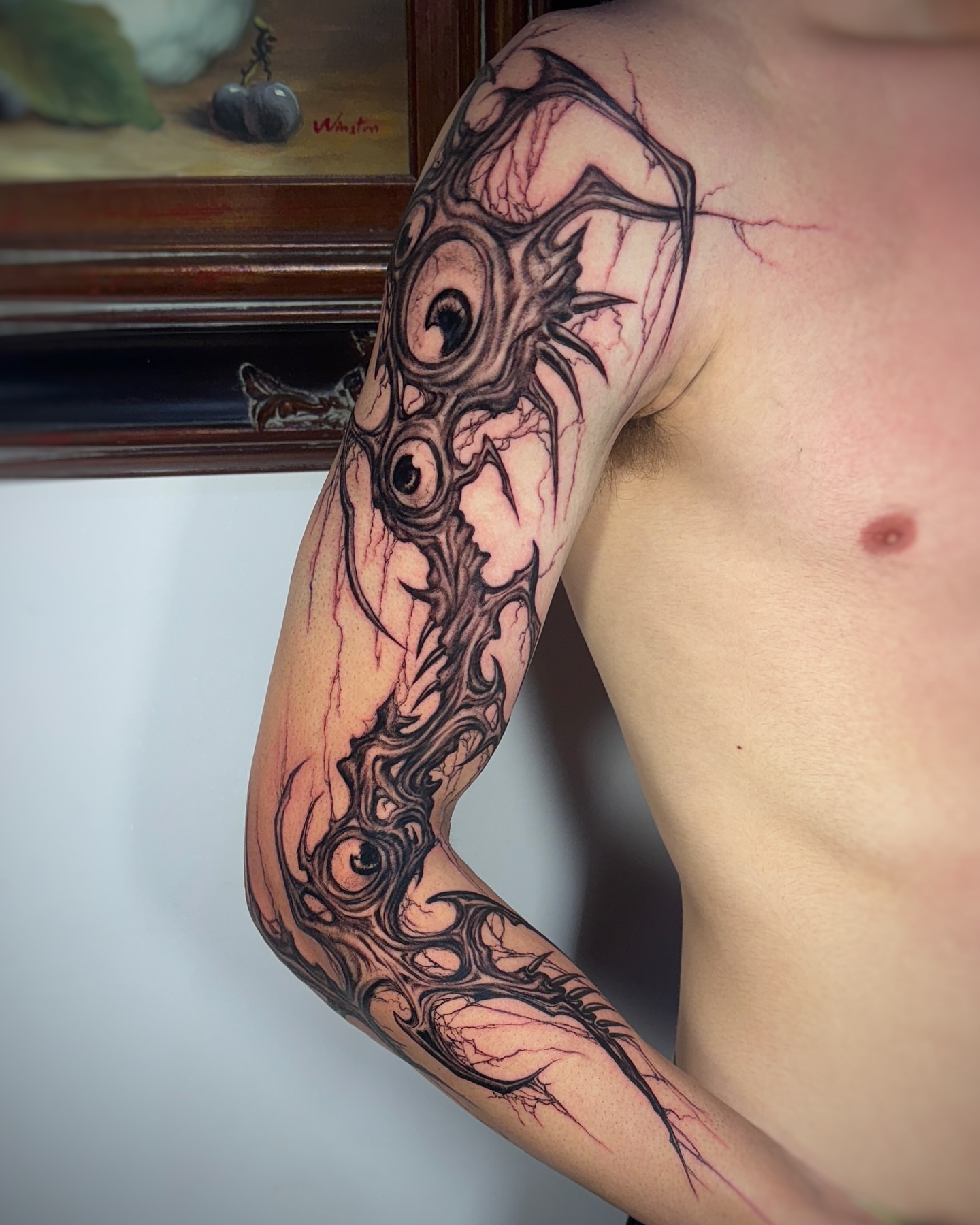 Eye and organic structure dark realism tattoo on the forearm by Jemin Ren
