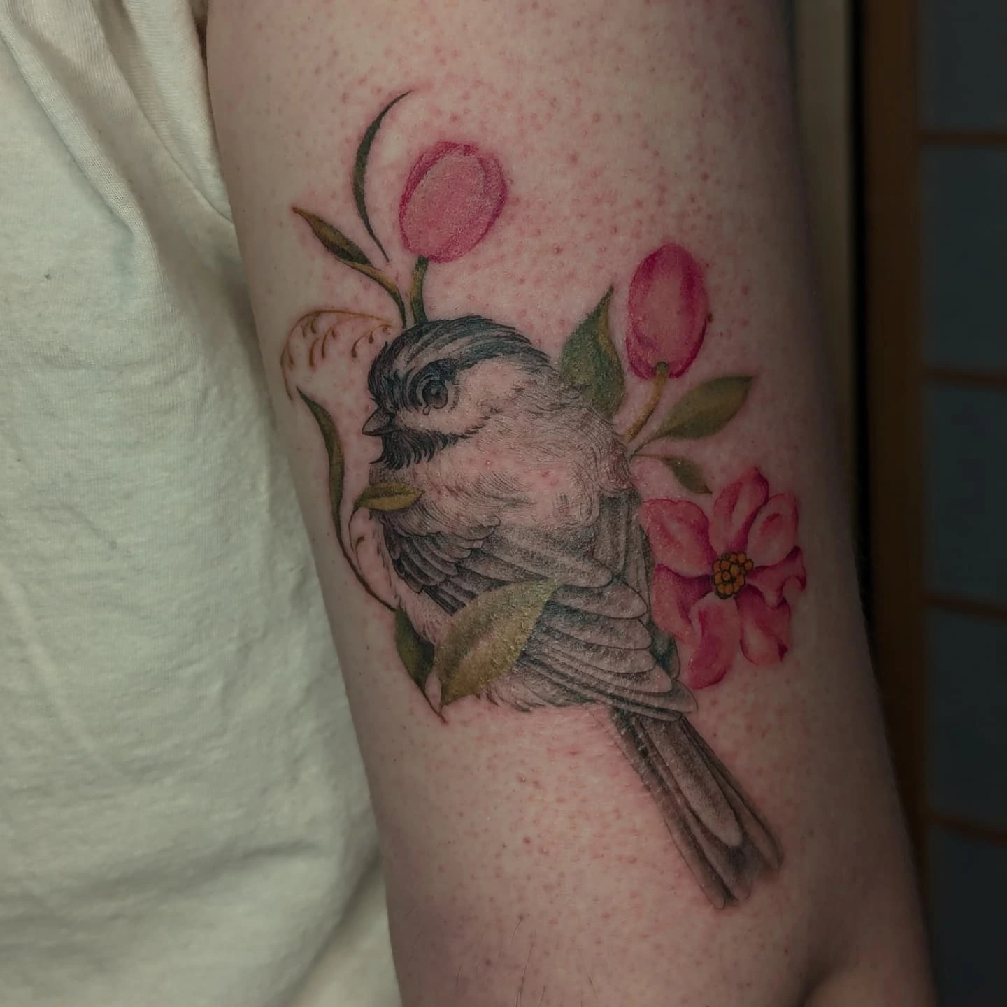 Bird and flowers realism tattoo on the forearm by Jeanine, Providence, Rhode Island