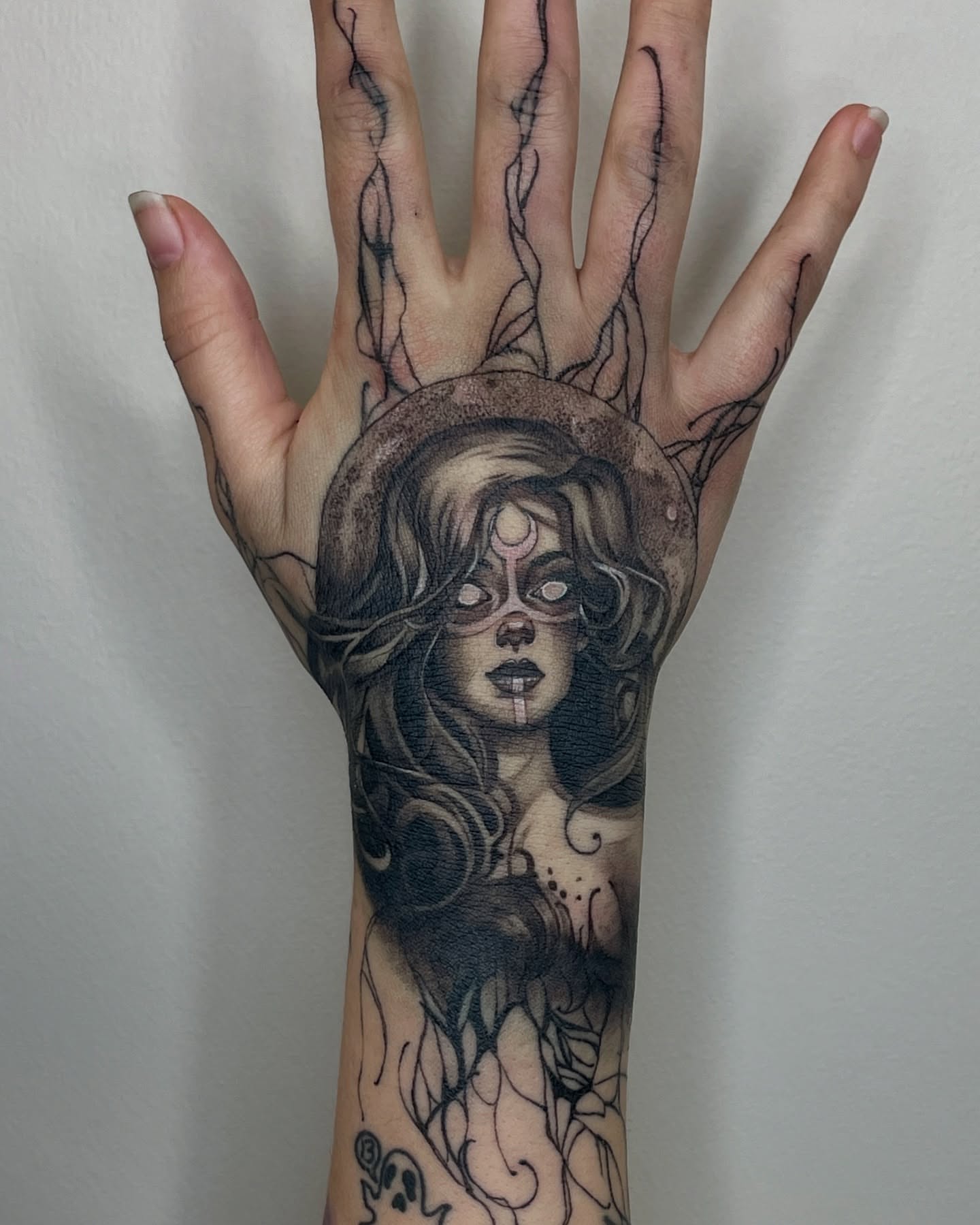 Woman with mask dark realism tattoo on the hand by Melissa Rose Moya