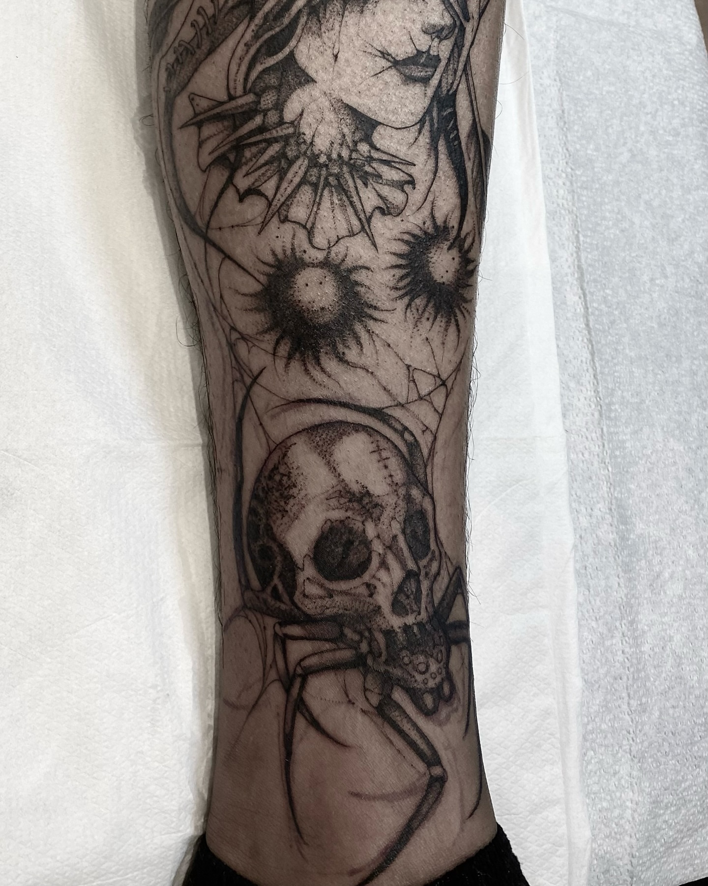 Skull and woman dotwork tattoo on the forearm by Becci Chelicerata