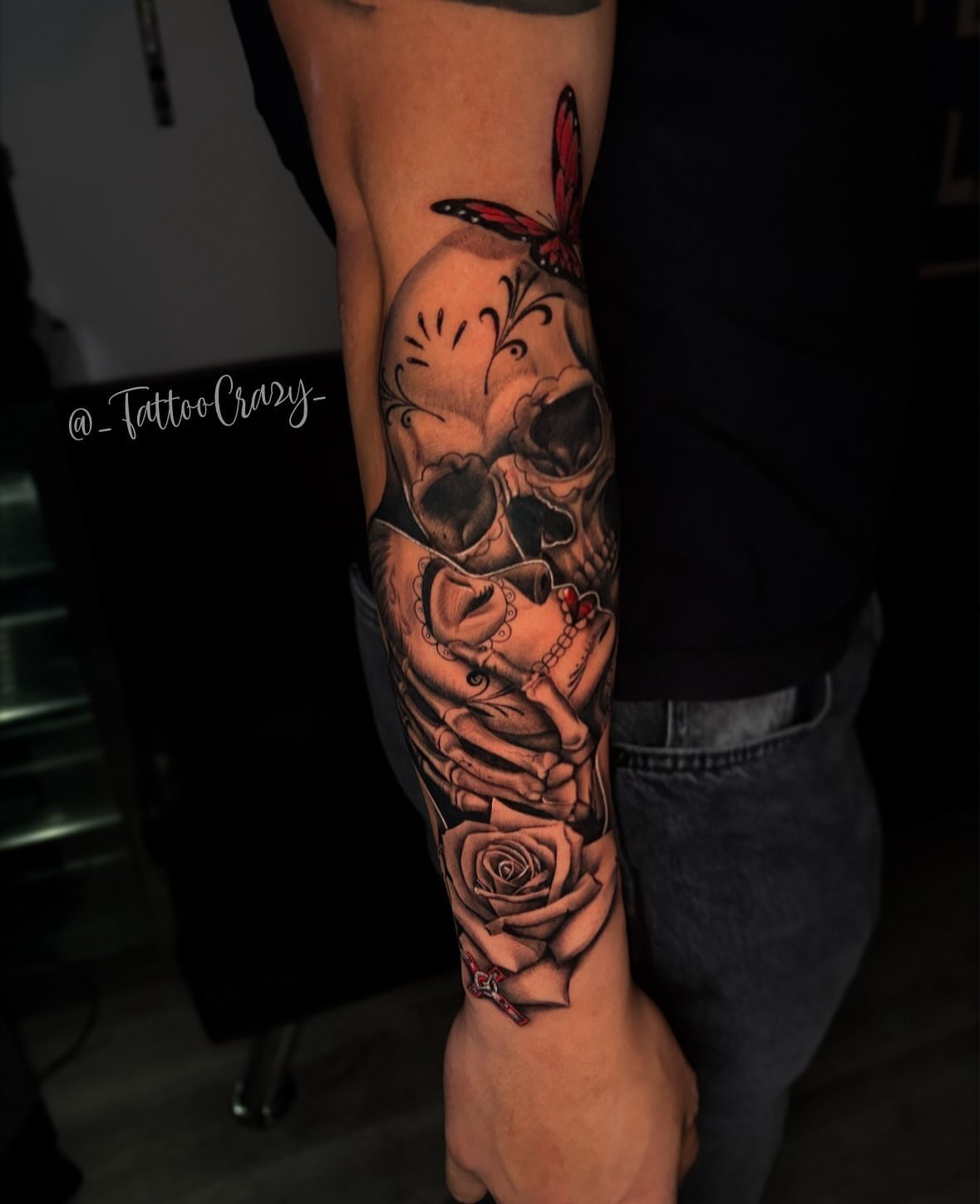 Skull and roses realism tattoo on the forearm by TattooCrazy🎭