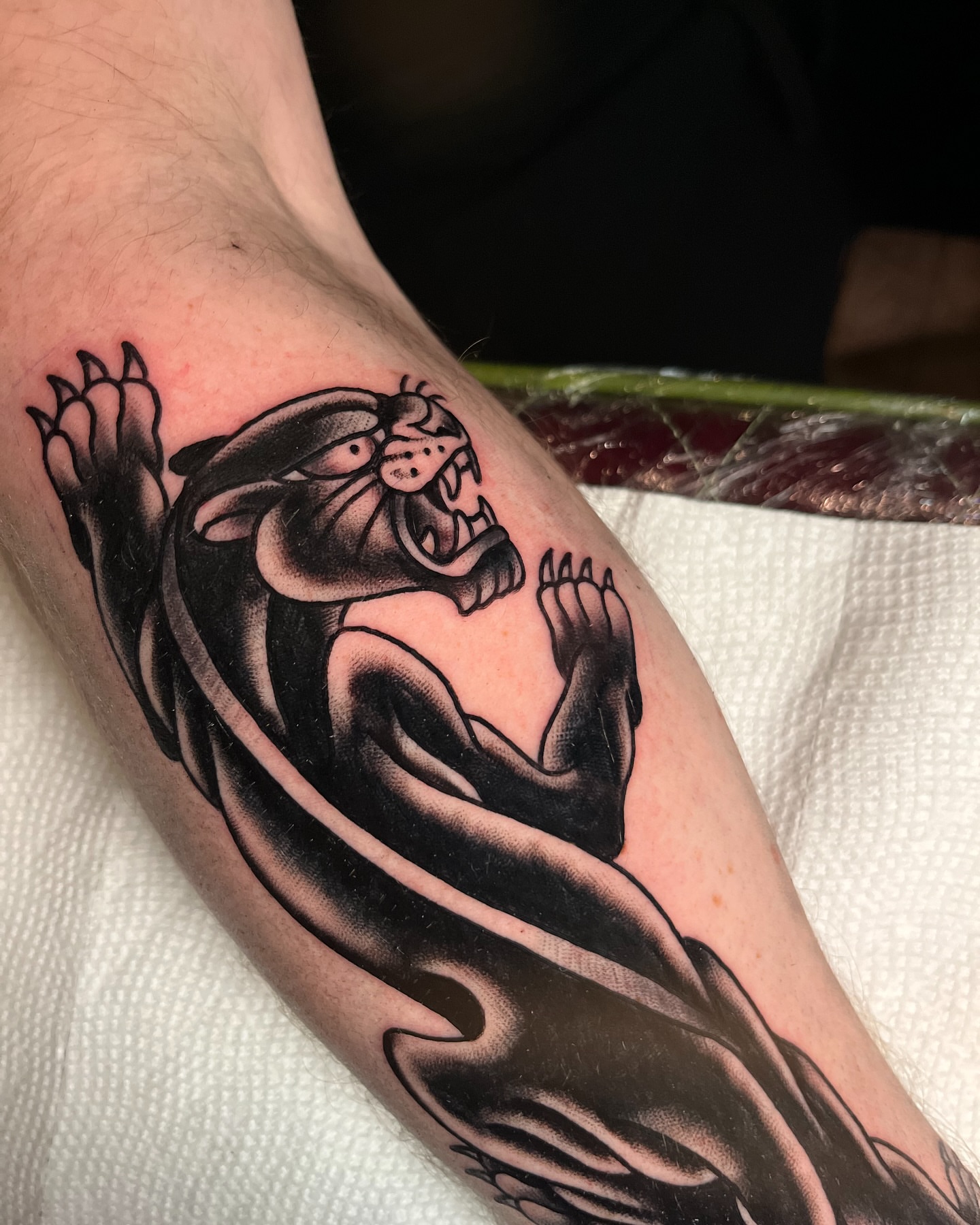 Panther black and grey tattoo on the forearm by πππ’π―π’π¨ πππΆπ©π¬π―π, Manchester, New Hampshire