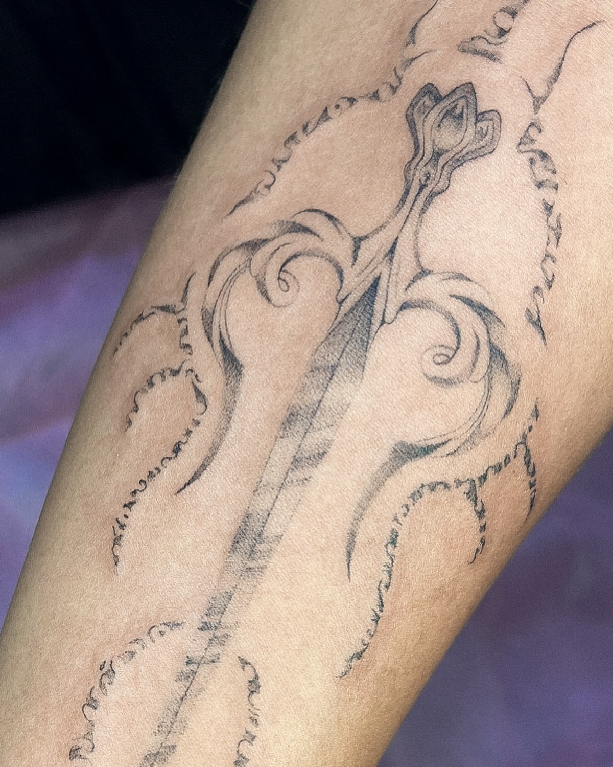 Sword and swirls black and grey tattoo on the forearm by Grace Zarmina Hessam