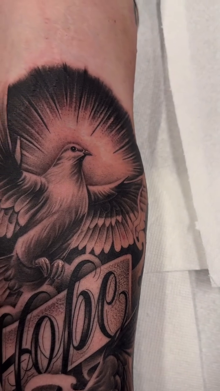 Dove with the word Hope realism tattoo by Antonio Pavić, Los Angeles, California