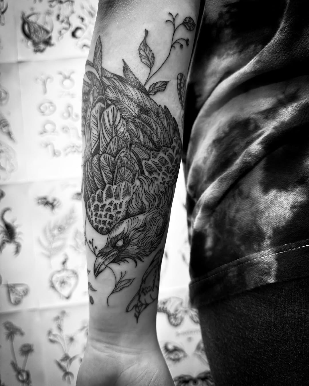 Raven with leaves fine line tattoo on the forearm by Thylacine Tattoo & Art, Los Angeles, California