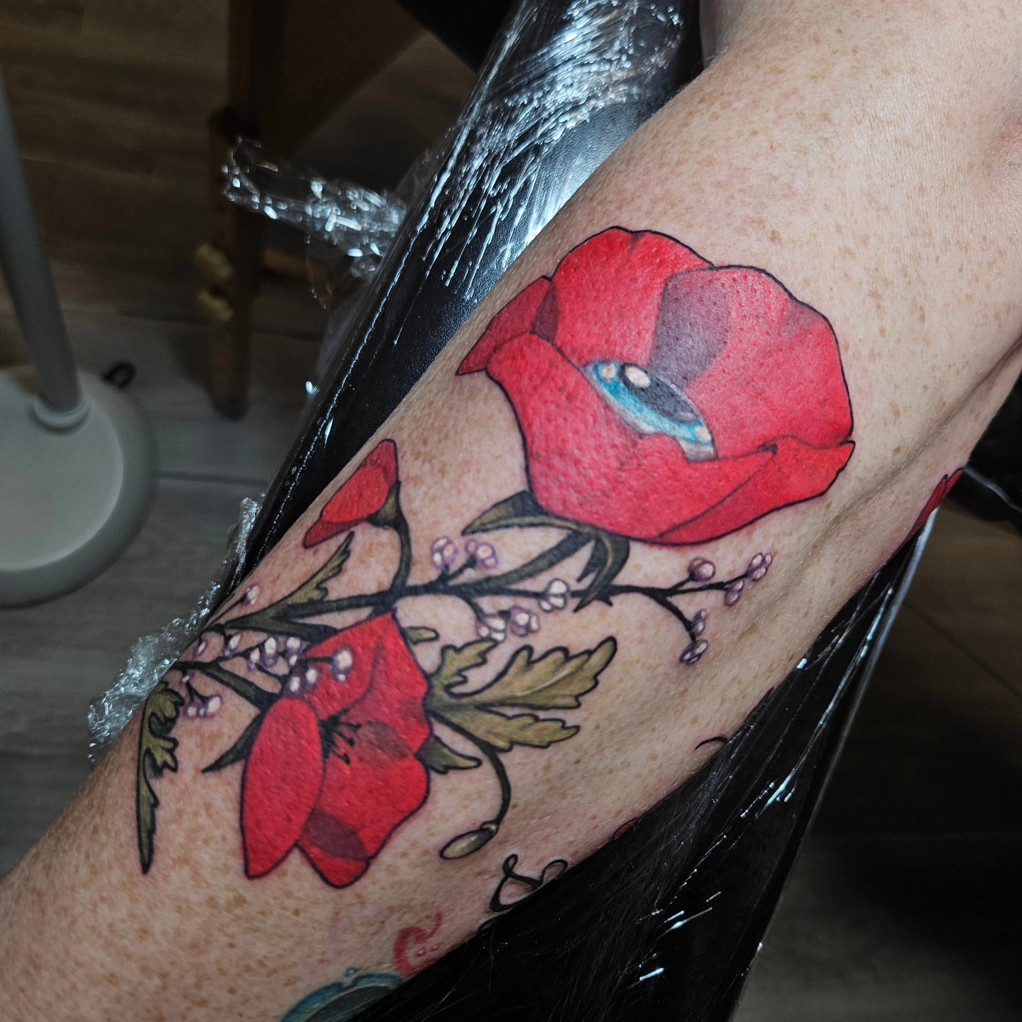 Red poppies watercolor tattoo on the forearm by Angell Tattoo Artist, Denver, Colorado