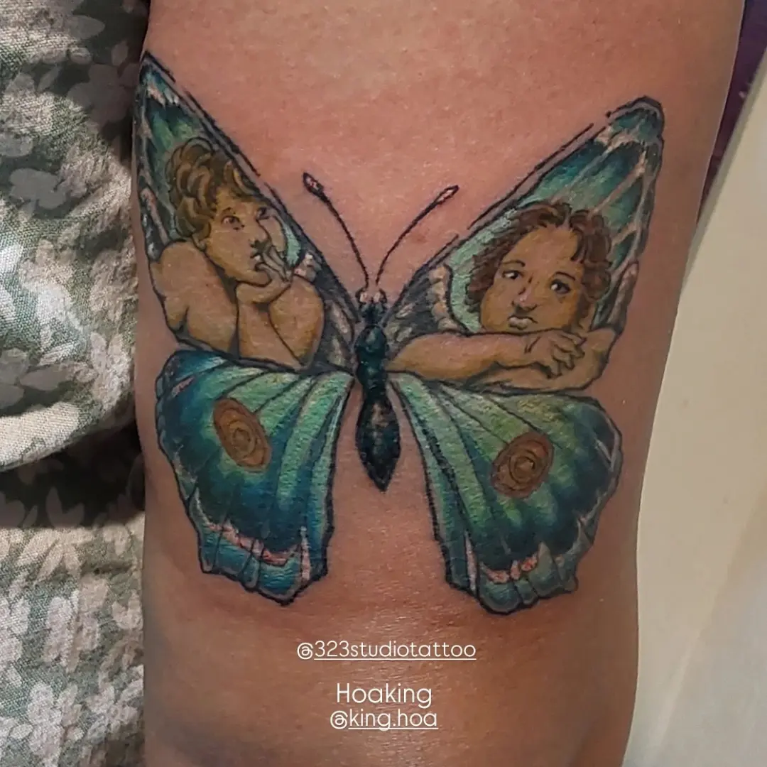 Butterfly with cherubs illustrative tattoo on the thigh by Hoa King