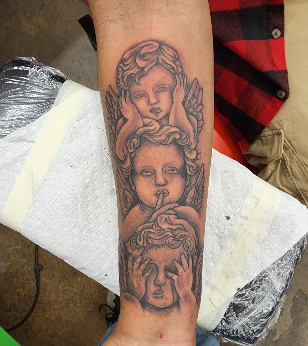 Cherubs black and grey tattoo on the forearm by @thedevilspaintbrush_