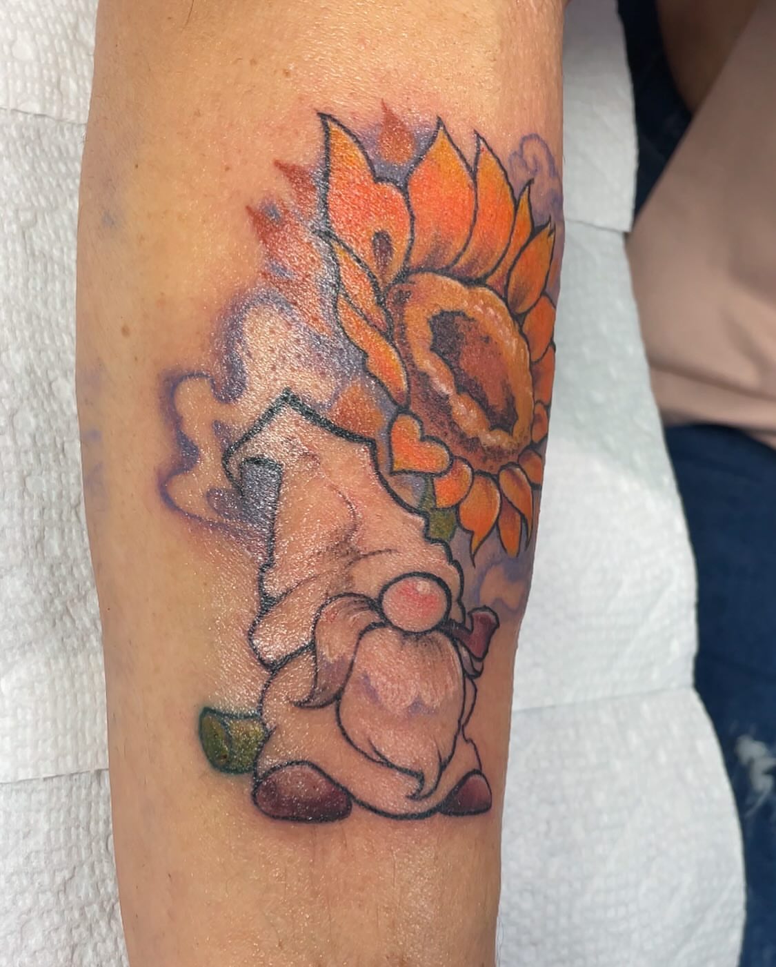 Sunflower and rabbit new school tattoo on the forearm by Robin Wintringham