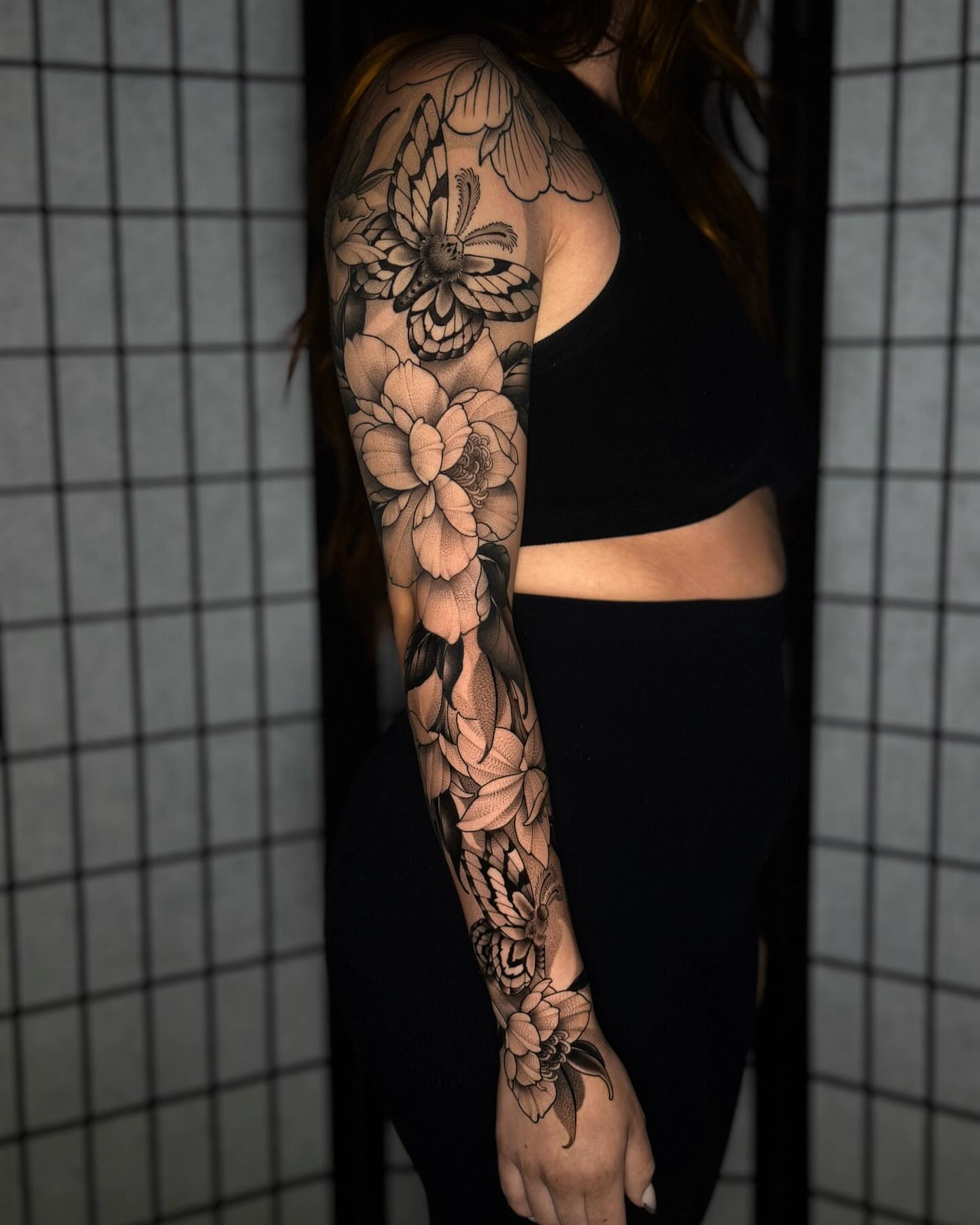Floral sleeve realism tattoo on the upper arm by San Diego