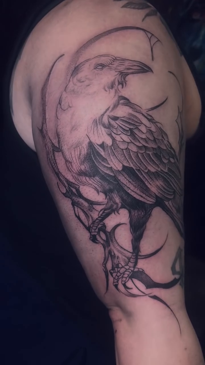 Raven on a branch with moon realism tattoo by Claire Litsey