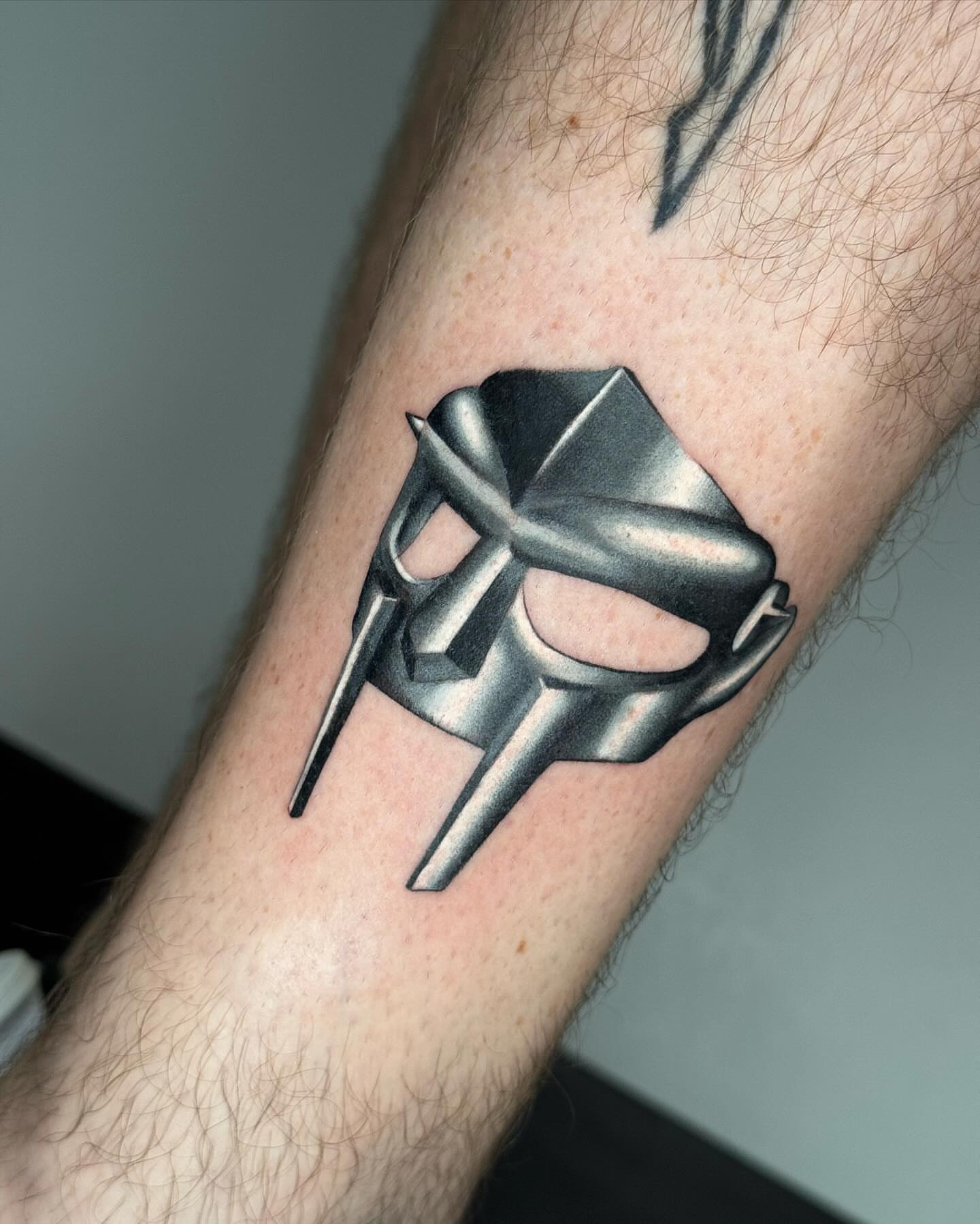 Helmet geometric tattoo on the forearm by Mel