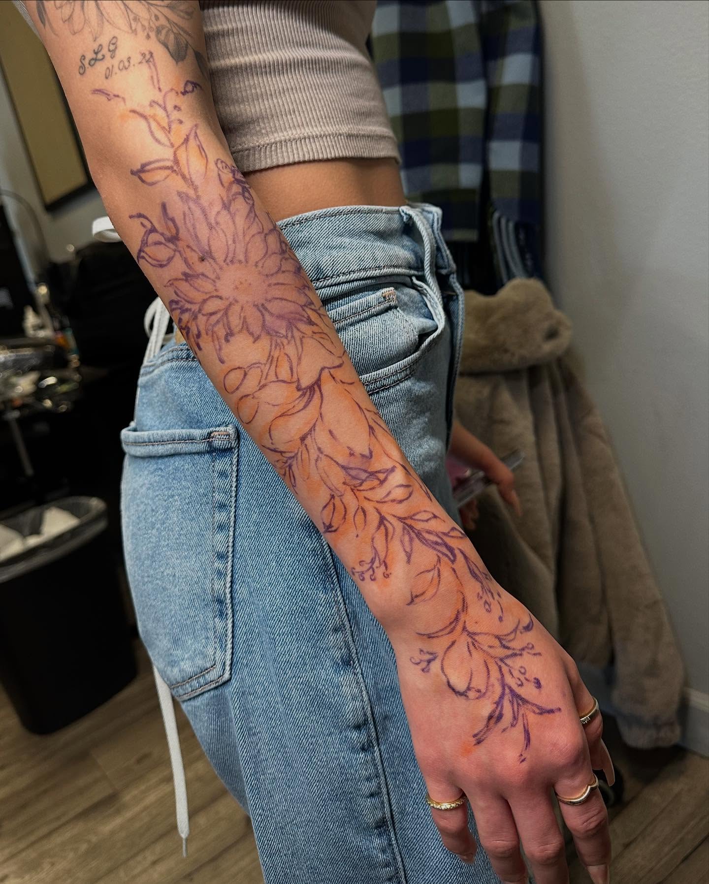 Floral design fine line tattoo on the forearm by Angel
