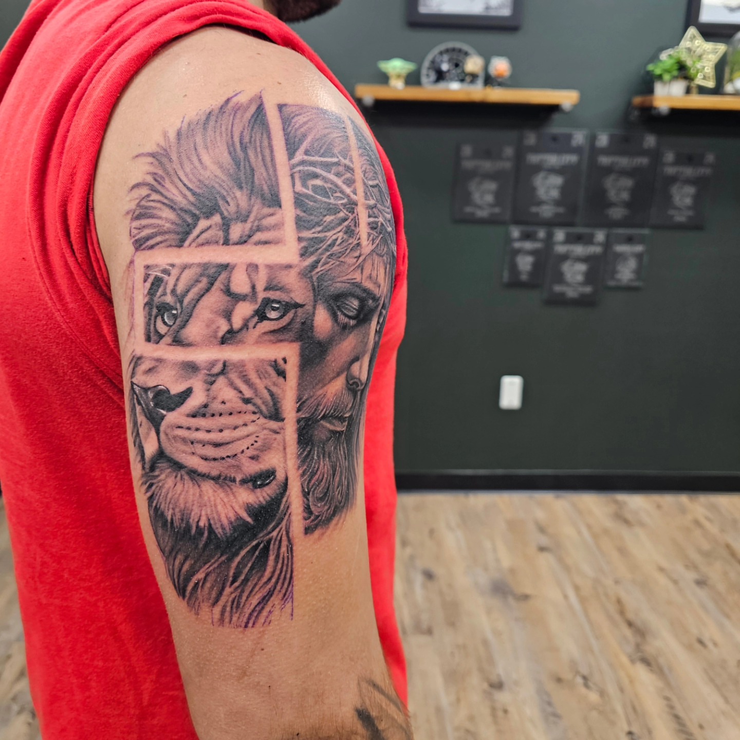 Lion realism tattoo on the upper arm by Derek Davis