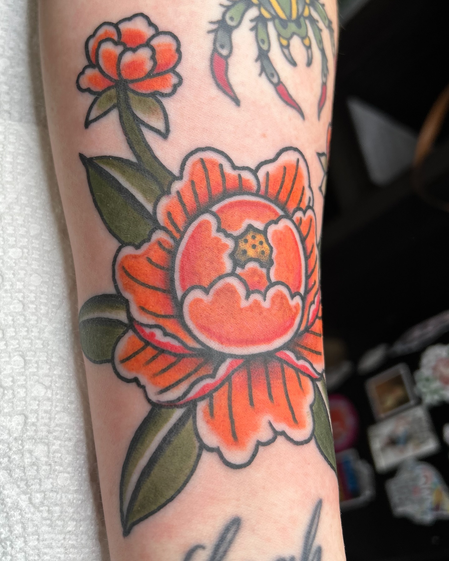 Peony American traditional tattoo on the forearm by Alex Fannin