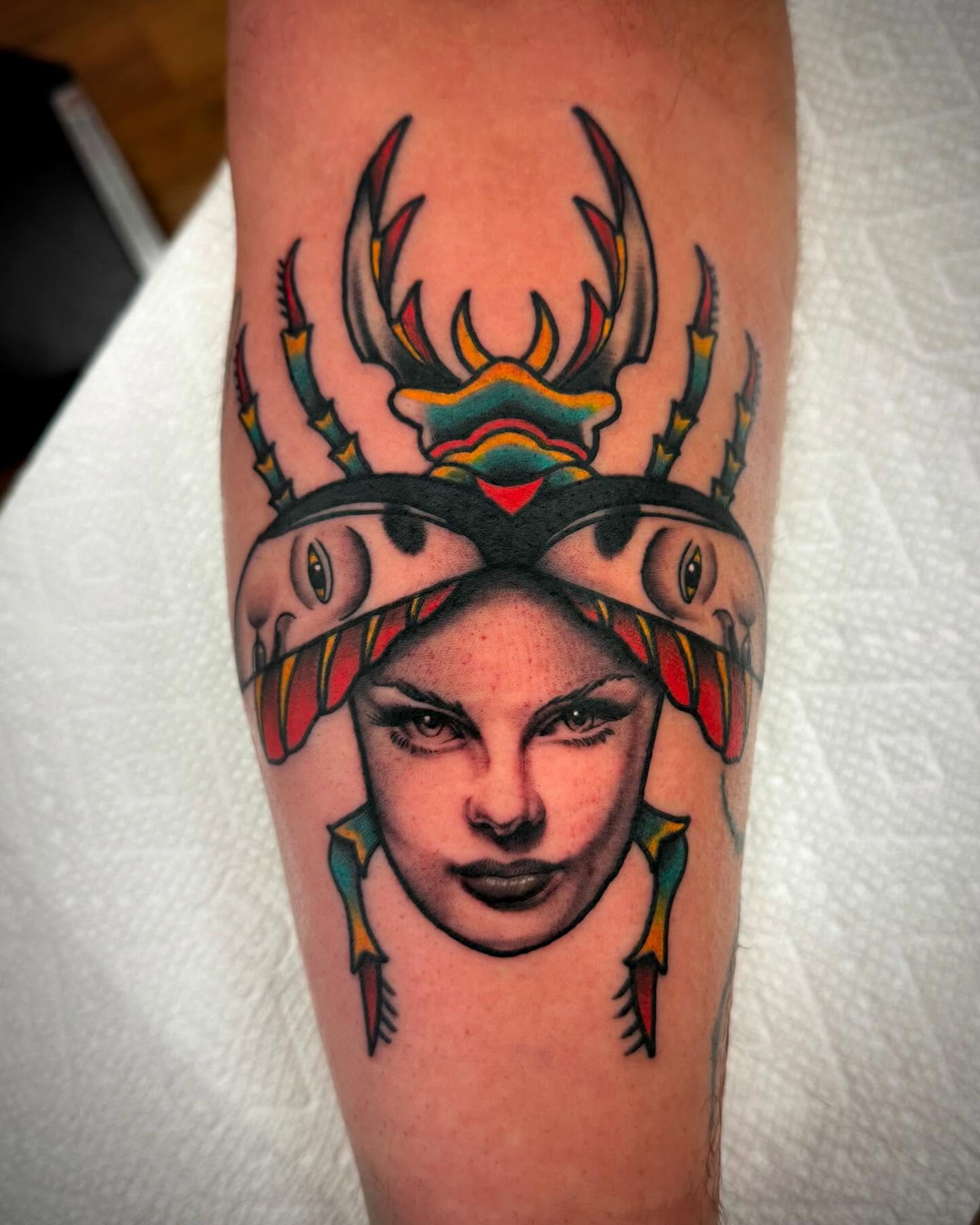 Woman with antlers American traditional tattoo on the forearm by Sam Babcock