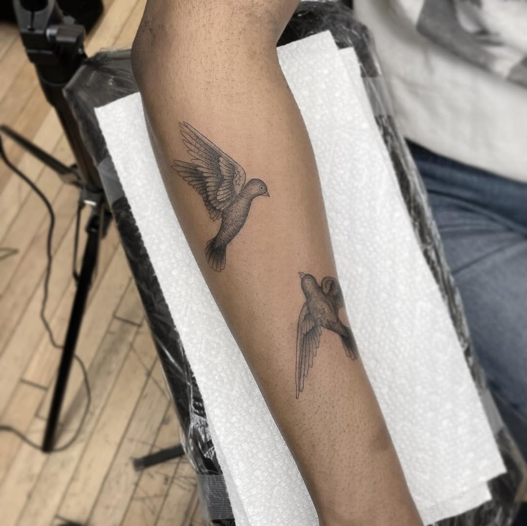 Two doves fine line tattoo on the forearm by Jesus A.