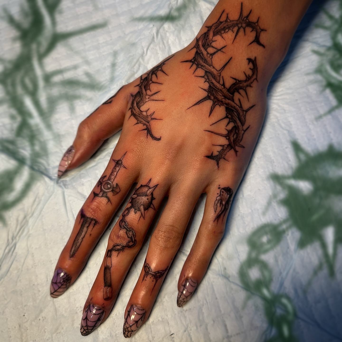 Thorn crown dark realism tattoo on the hand by Jason