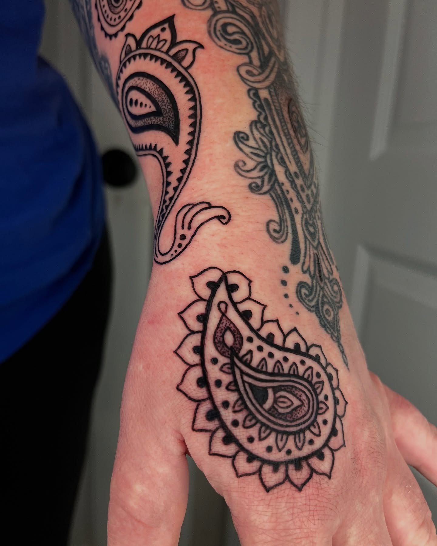 Paisley black and grey tattoo on the forearm by layne