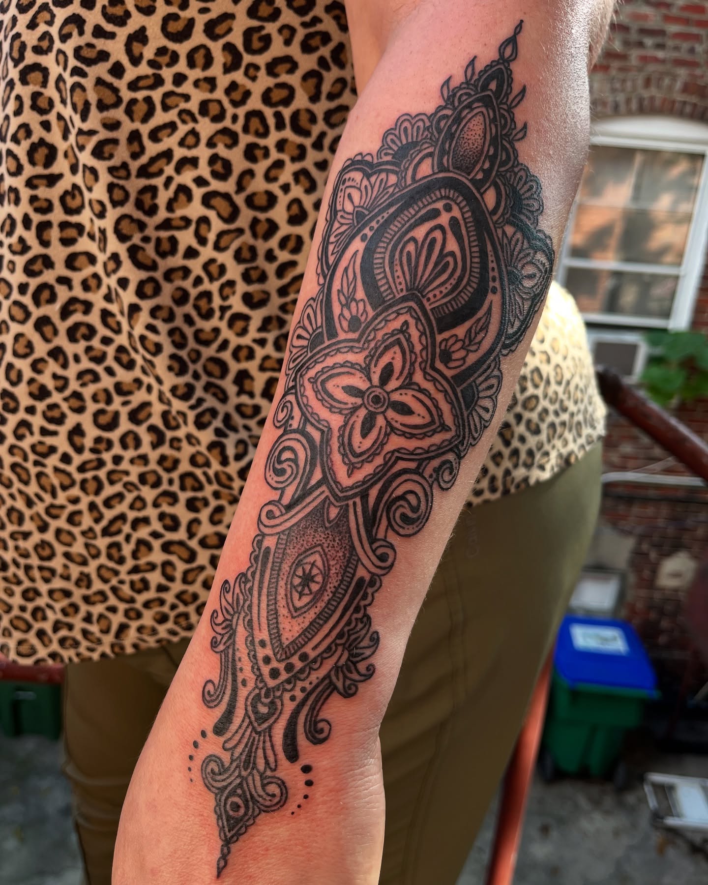 Mandala black and grey tattoo on the forearm by layne