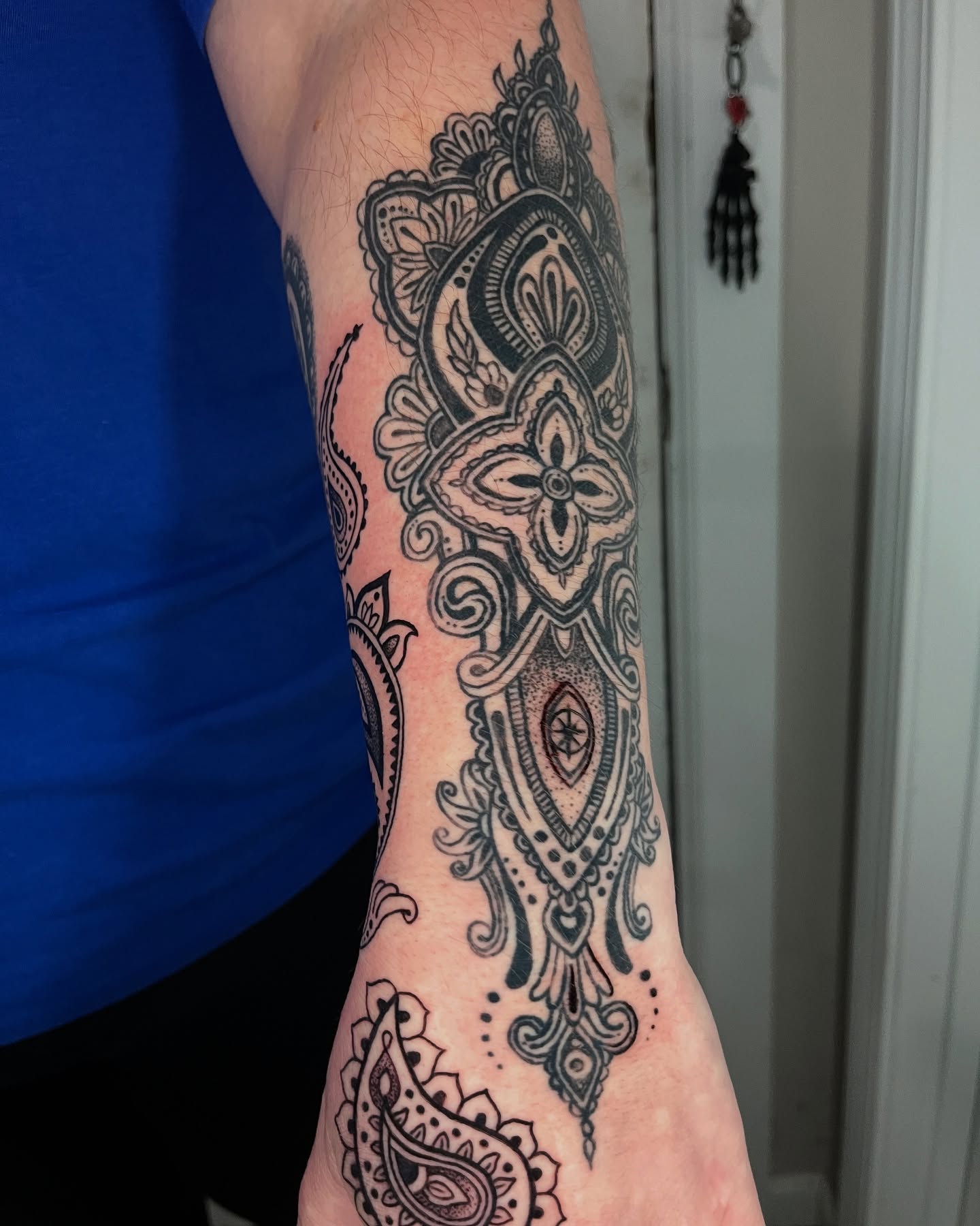 Paisley and floral ornamental tattoo on the forearm by layne