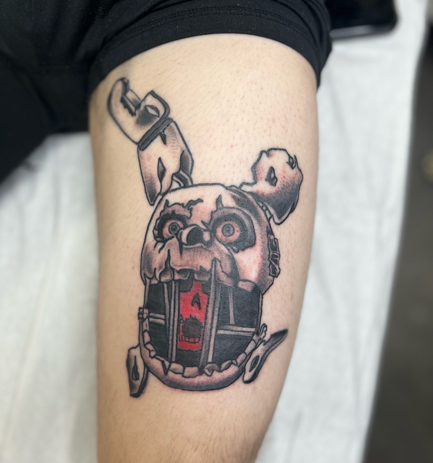 Mechanical bulldog black and grey tattoo on the thigh by Ashley Camp