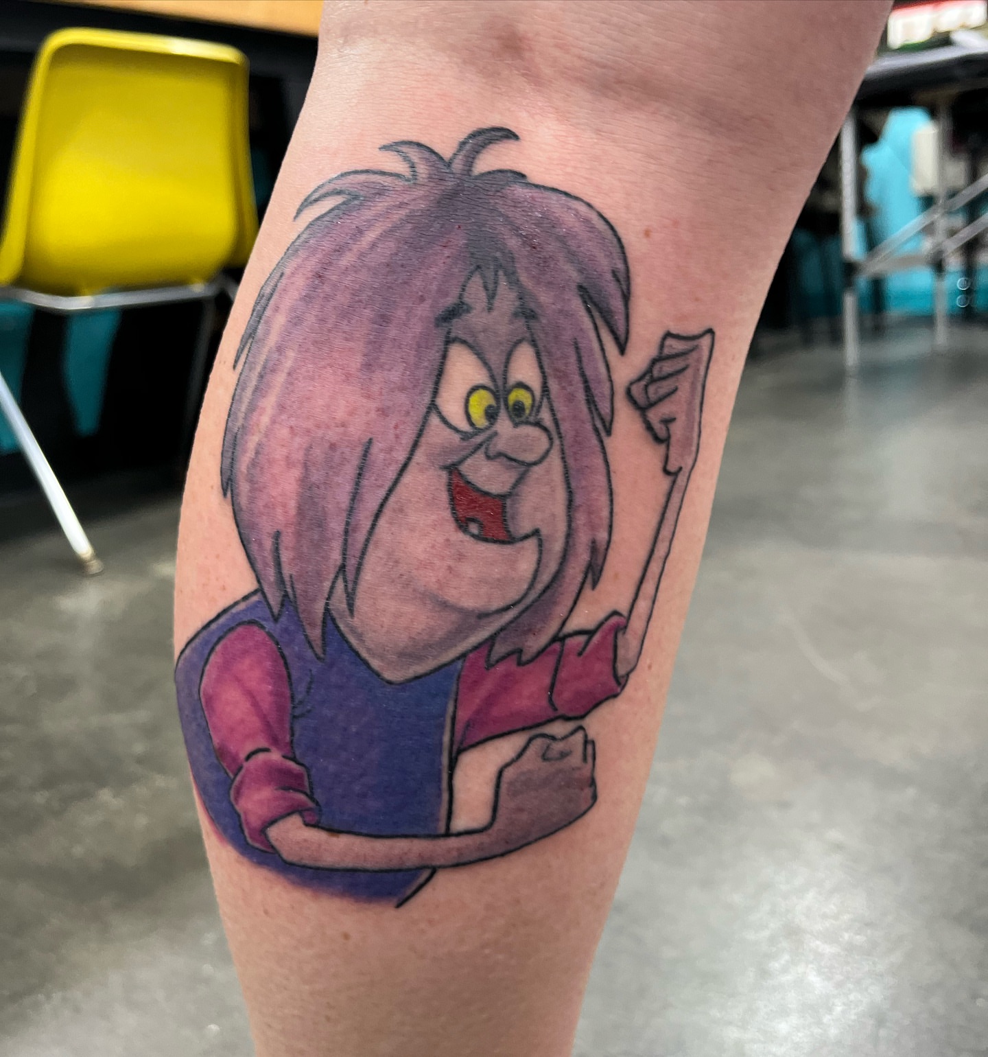 Purple-haired character dotwork tattoo on the forearm by Ashley Camp