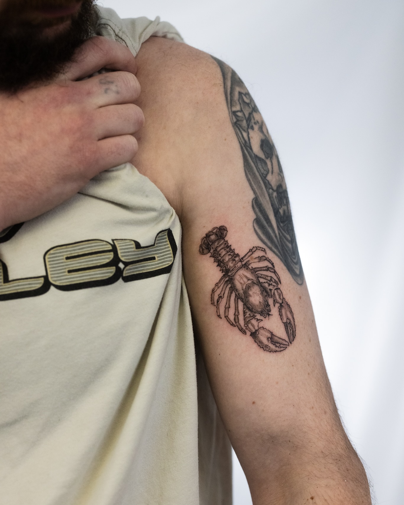 Lobster realism tattoo on the upper arm by Ben Cisek