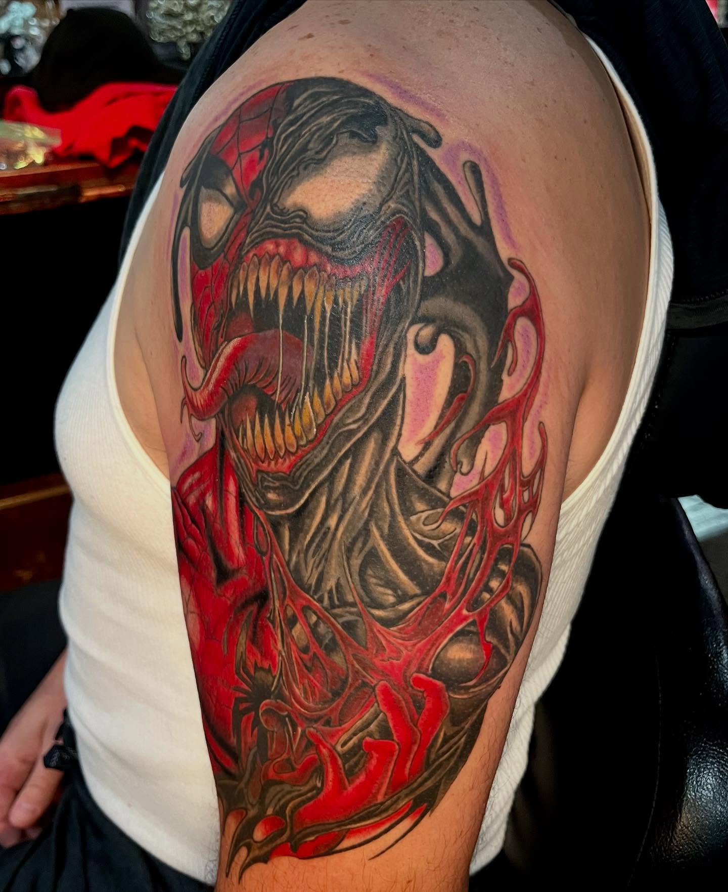 Venom dark realism tattoo on the shoulder by Kenny Buck