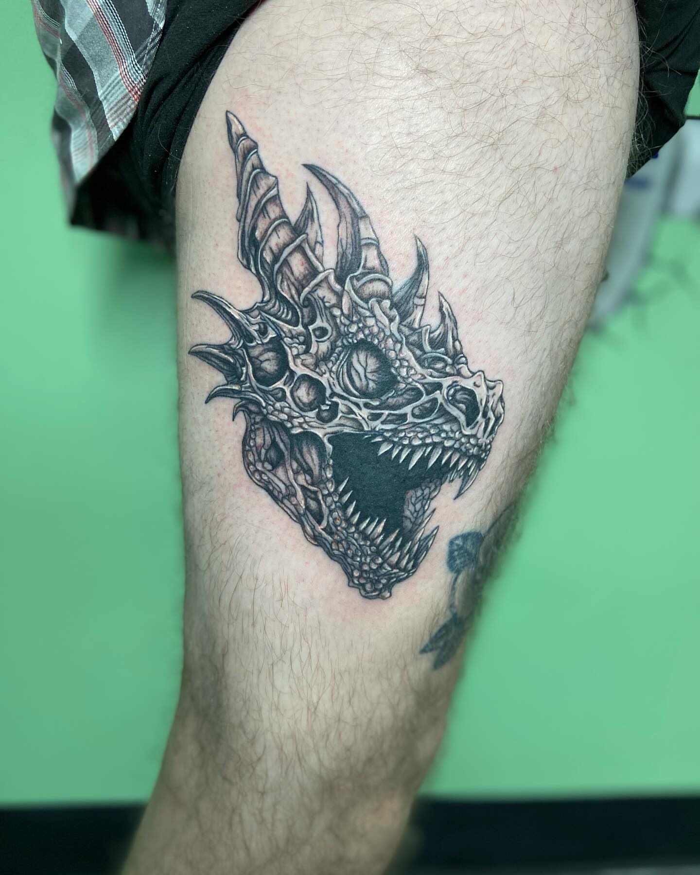 Dragon head black and grey tattoo on the thigh by ✶ teryn ✶, Akron, Ohio