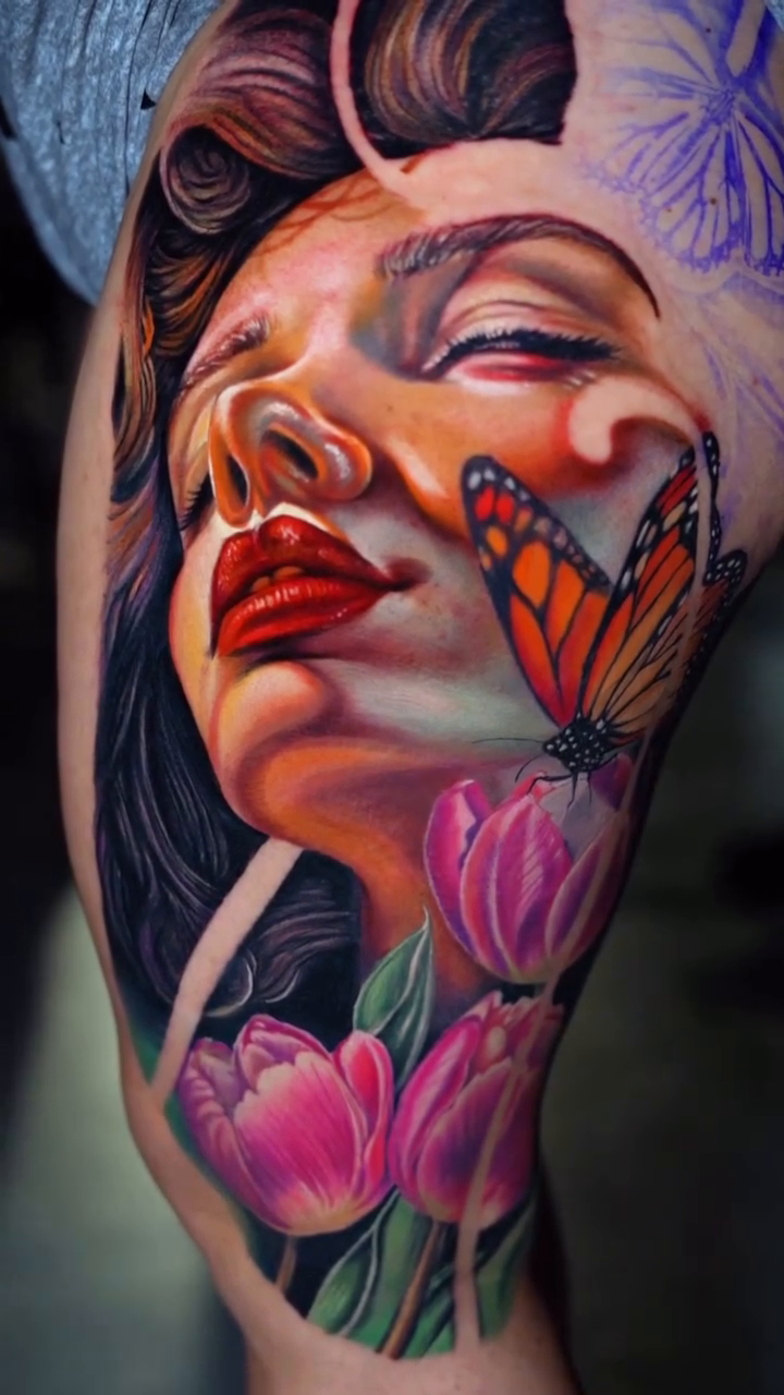 Woman with butterfly and tulips realism tattoo by Yasmani ramirez