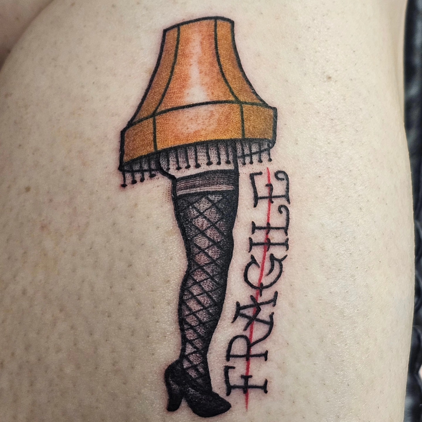 Leg with Christmas lamp black and grey tattoo on the thigh by BZ Artistry