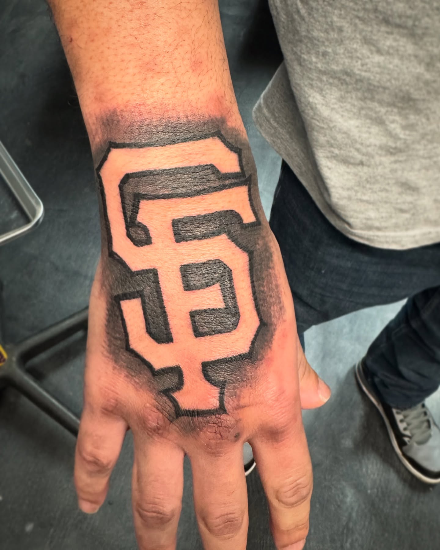 SF logo black and grey tattoo on the hand by ♟️SouthEastLA♟️