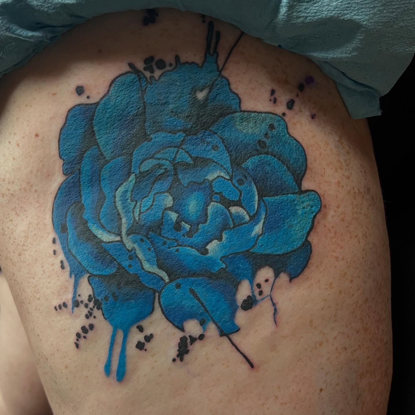Blue flower dotwork tattoo on the thigh by Katie Sayre