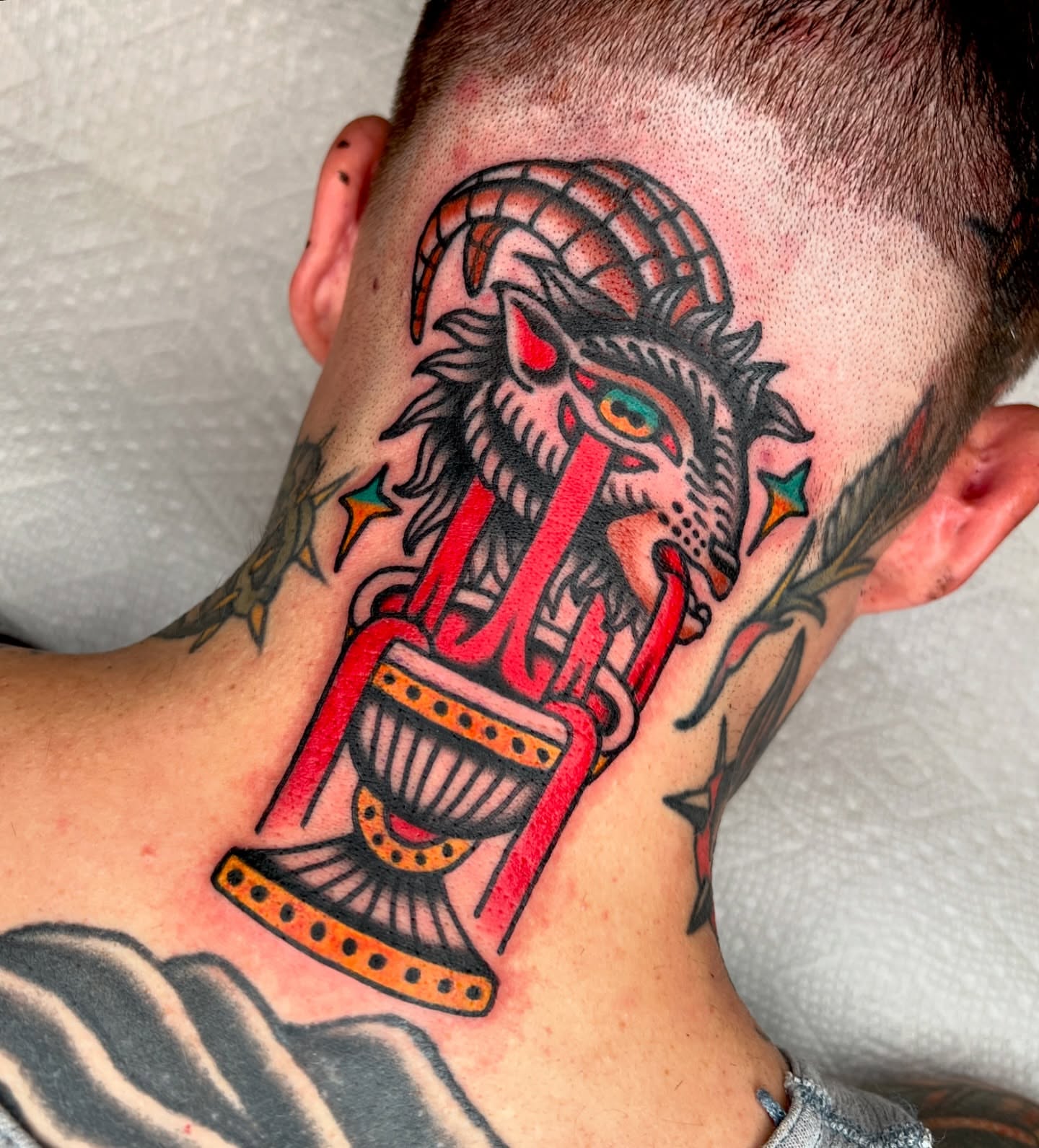 Dragon and hourglass American traditional tattoo on the neck by Ian Jett