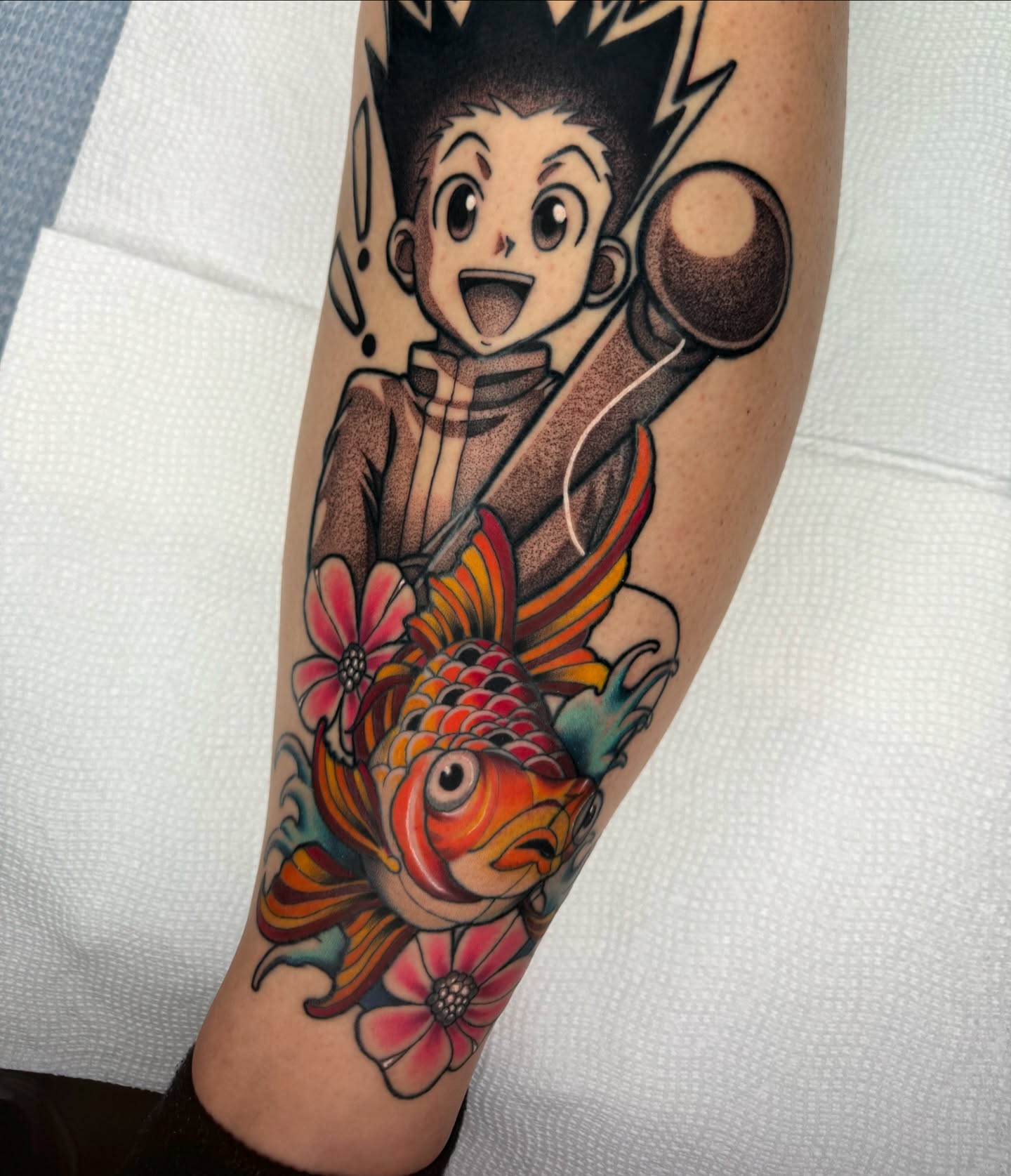 Astarboy and koi fish anime tattoo on the forearm by Luis Torres, Harrison, New Jersey