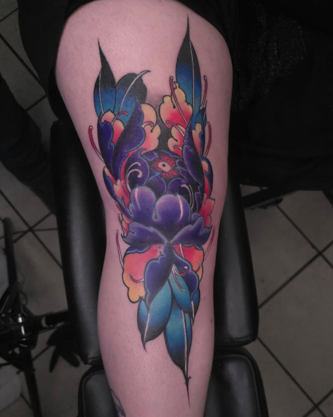 Peony and leaves watercolor tattoo on the thigh by BoogaInk