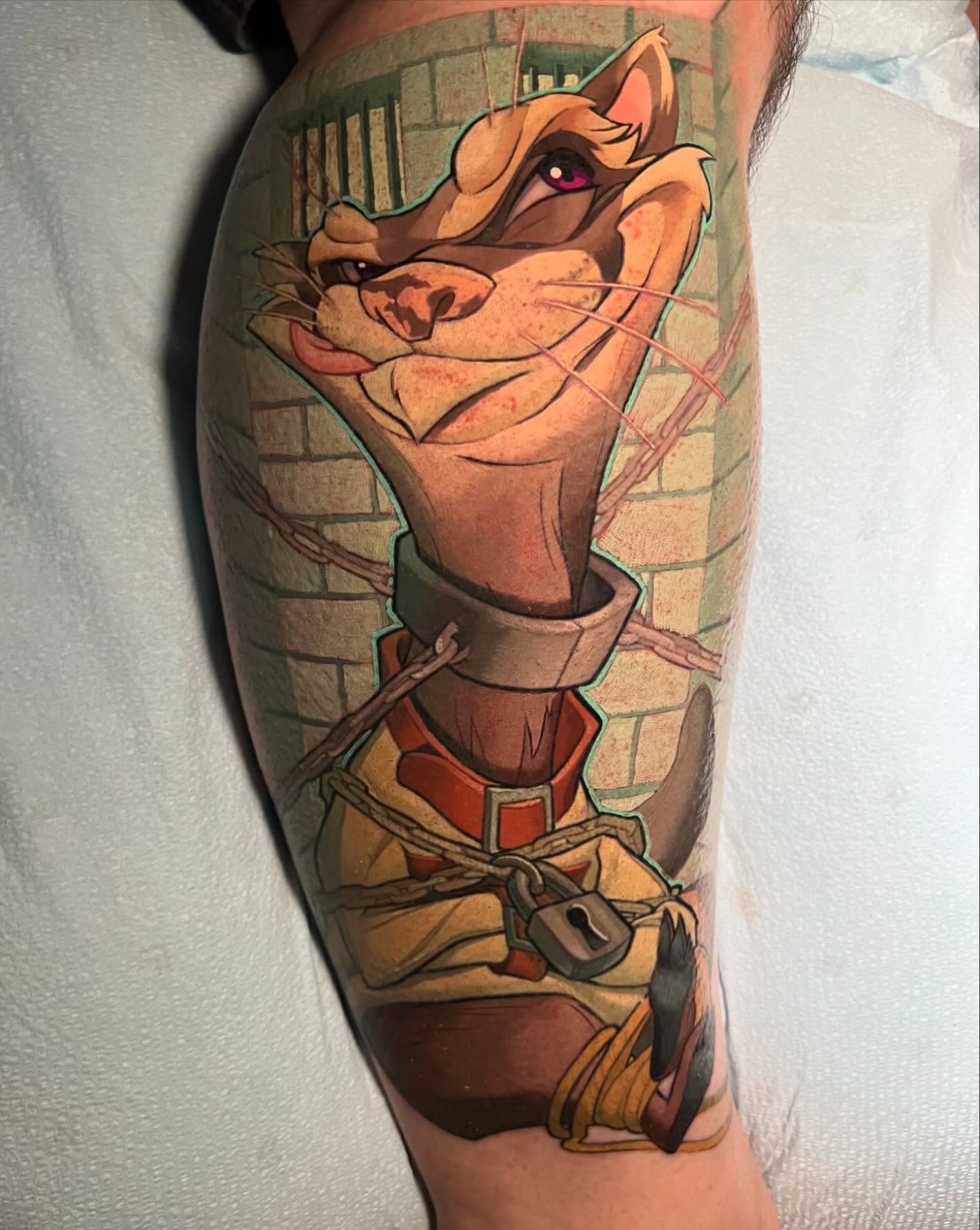 Cat character realism tattoo on the forearm by Tim Stafford
