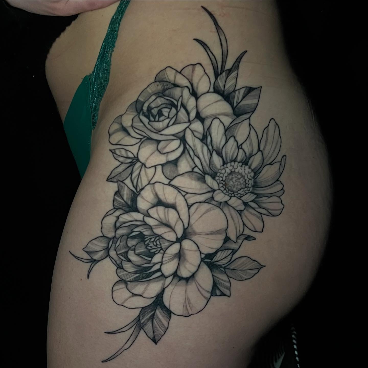 Floral bouquet realism tattoo on the thigh by Brooke, Kansas City, Missouri