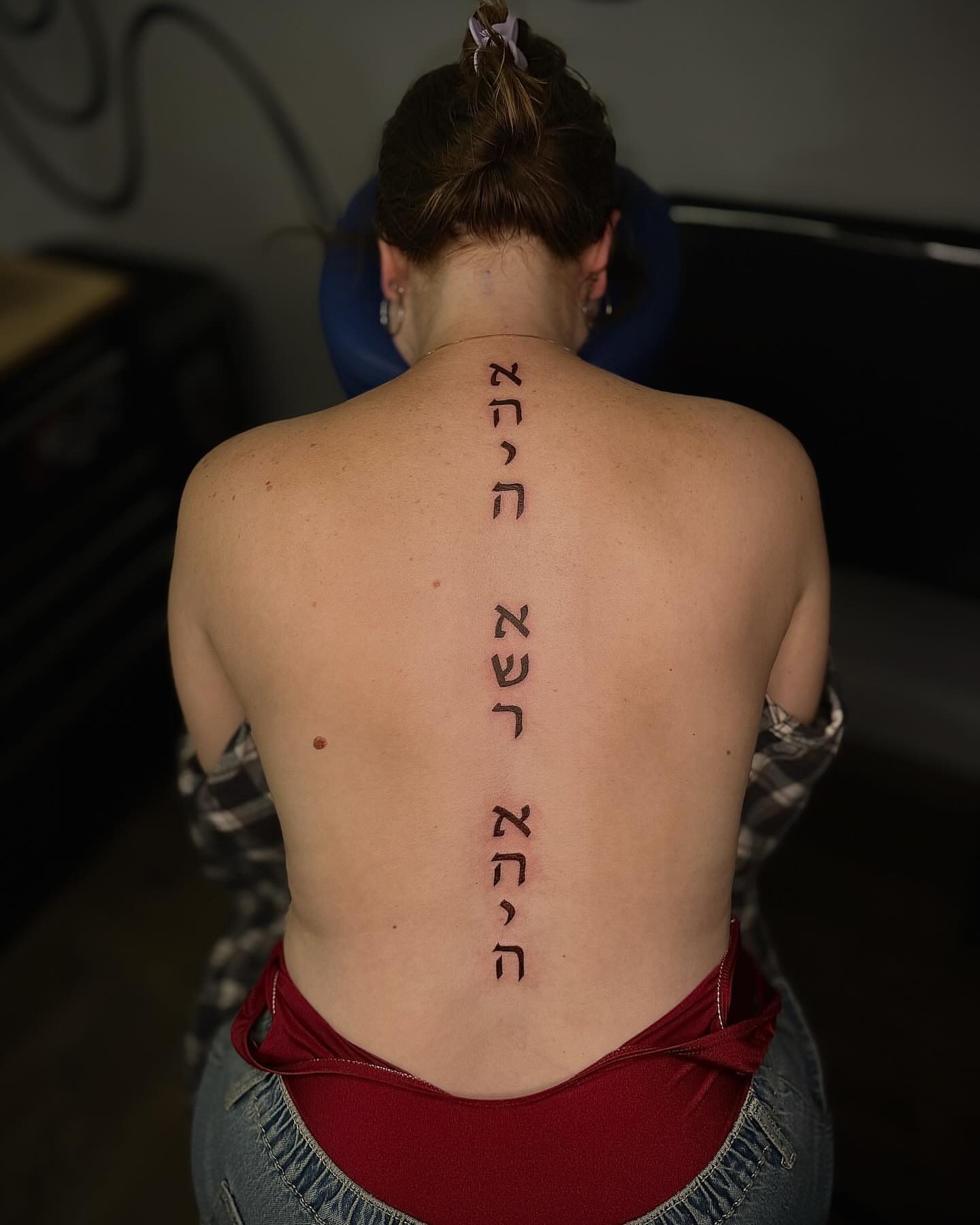 Hebrew script lettering script tattoo on the back by Jewels, St. George, Utah