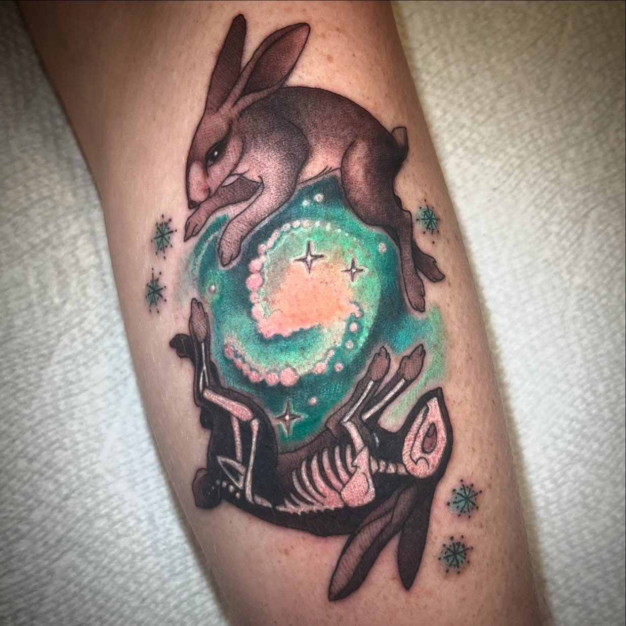 Rabbit and skeleton dotwork tattoo on the forearm by Jessica Brown