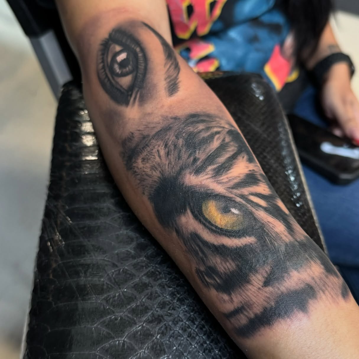 Lion eyes realism tattoo on the forearm by Joseph Marshall